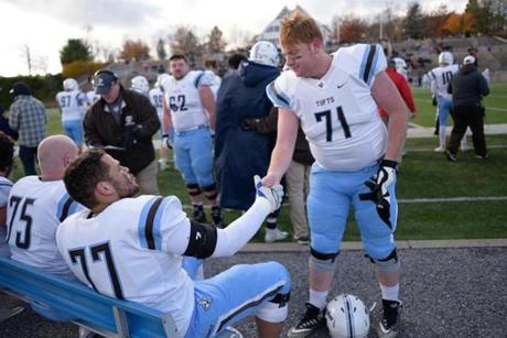 Tufts football players Tim Reitzenstein and Dan Dewing congratulated each other during their final game together against Middlebury College.

