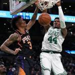 Boston, MA 12-19-18: The Celtics Robert Williams (44) slams home two first half points over the Suns Kelly Oubre Jr. (3). The Phoenix Suns visited the Boston Celtics for a regular season NBA basketball game at T.D. Garden. (Jim Davis/Globe Staff)