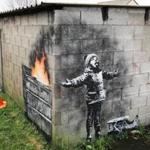 PORT TALBOT, WALES - DECEMBER 20: People gather around fences that have been erected to protect the latest piece of artwork by the underground guerrilla artist Banksy on December 20, 2018 in Port Talbot, Wales. The British graffiti artist who keeps his identity a secret, confirmed yesterday that the artwork was his using his verified Instagram account to announce 