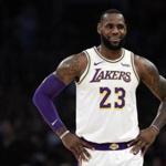 Los Angeles Lakers' LeBron James (23) smiles during a break in action during the first half of an NBA basketball game against the Memphis Grizzlies Sunday, Dec. 23, 2018, in Los Angeles. (AP Photo/Marcio Jose Sanchez)