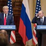 President Trump, left, speaks, as Vladimir Putin, Russia's president, listens during a news conference in Helsinki, Finland, on July 16. MUST CREDIT: Bloomberg photo by Chris Ratcliffe
