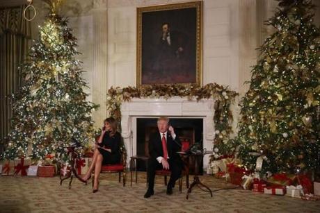 WASHINGTON, DC - DECEMBER 24: U.S. President Donald Trump (R) and first lady Melania Trump take phone calls from children as they participates in tracking Santa Claus' movements with the North American Aerospace Defense Command (NORAD) Santa Tracker on Christmas Eve in the East Room of the White House December 24, 2018 in Washington, DC. This is the 63rd straight year that NORAD has publicly tracked Santas sleigh on its global rounds. (Photo by Chip Somodevilla/Getty Images)
