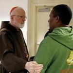 Boston, MA - 12/25/2018- ] Cardinal Seán Patrick O'Malley speaks to Jose Luiz Sotob during a Christmas Day luncheon and prayer service for the poor and homeless at St. Francis House. (Michael Swensen for The Boston Globe) Topic: (Metro) 