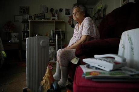 Ella May Broaddusx, 83, sat in her Academy Homes apartment with a space heater to keep warm while she watched TV. Approximately 500 residents of the Roxbury housing development have been living without gas service. 
