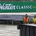 Large graphics are placed around Notre Dame Stadium as crews work to set up the stadium for the NHL Winter Classic game between the Chicago Blackhawks and the Boston Bruins Friday, Dec. 21, 2018, in South Bend, Ind. (Robert Franklin/South Bend Tribune) MUST CREDIT