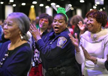 Boston-12/28/18 Boston Police officer Cynthia Brewington from Area B3 gets into the rhythm on the dance floor at the Seaport World Trade Center. Close to 2300 seniors from the City of Boston filled the huge hall during the annual Mayor's Senior First Night celebration. They were treated to a hot lunch, music and dancing. Photo by John Tlumacki/Globe Staff(metro)
