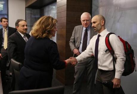 Peter DeMarco shook hands with Lynette Alberti, chief nursing officer, when he met with hospital executives Nov. 13 to discuss the death of his wife, Laura Levis.

