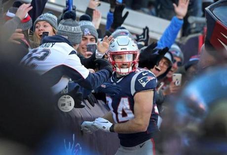 Foxborough, MA 12-30-18:Patriots running back Rex Burkhead celebrates with fans in the end zone aftre he caught a second quarter touchdown pass from quarterback Tom Brady (not pictured). The New England Patriots hosted the New York Jets in a regular season NFL football game at Gillette Stadium. (Jim Davis/Globe Staff)
