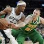 Boston Celtics' Daniel Theis, right, attempts to steal the ball from San Antonio Spurs' Dante Cunningham during the second half of an NBA basketball game, Monday, Dec. 31, 2018, in San Antonio. (AP Photo/Darren Abate)