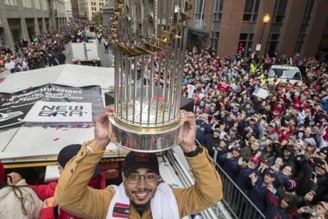 Mookie Betts hoisted the World Series trophy at the Red Sox victory parade.
