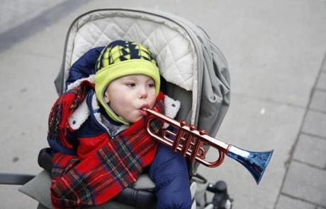 Beau Bodnar, 3, of Boston rang in the New Year a little early as his parents pushed him down Boylston Street to take in the ice sculptures at the First Night celebration in Boston. Jessica Rinaldi/Globe Staff
