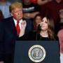 President Donald Trump listens as Chair of the Republican National Committee, Ronna McDaniel, right, speaks during a campaign rally Monday, Nov. 5, 2018, in Cape Girardeau, Mo. (AP Photo/Jeff Roberson)