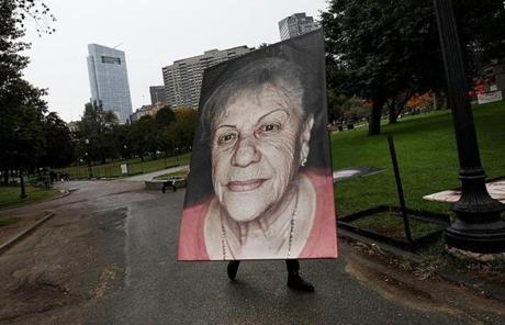 BGPOY SLIDER2018 Boston, MA., 10/15/2018, Artist Luigi Toscano and his crew set up big photographic portraits of Holocaust survivors in the Boston Common. This is part of a German project involving making portraits of Holocaust survivors. Suzanne Kreiter/Globe staff 

