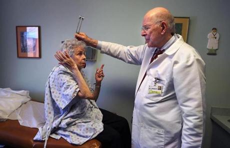 BGPOY SLIDER2018 milton -02/21/18 Dr. Manfred Ernesti, 88, is an endrocrinologist at Beth Israel Deaconess Hospital-Milton. He examines his long-time patient, Emma Odenveller from Dorchester, holding a tuning fork on her head to check her hearing, as she covers her right ear. John Tlumacki/Globe Staff(metro) 
