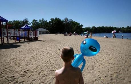 BGPOY SLIDER2018 Wilmington, MA- June 10, 2017: Connor Biscan walks the beach with a blow-up alien while visiting Silver Lake with his family in Wilmington last June. His mother, Roberta Biscan, suspected soon after Connor was born that something was wrong, but her family thought she was being dramatic. He had rituals, such as counting ceiling fan blades, and an obsession with balloons. He was diagnosed with autism at age two. 