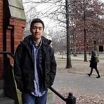 Harvard University graduate Jin K. Park, who holds a degree in molecular and cellular biology, poses at Harvard Yard in Cambridge, Mass., Thursday, Dec. 13, 2018. Park, who was named a Rhodes Scholar along with 30 other Americans in November, entered the U.S. illegally as a child, moving to Queens borough of New York City with his family. The undocumented student, who participates in the Deferred Action for Childhood Arrivals program (DACA), is not sure if he'll be allowed back in the U.S. after his studies in the United Kingdom. (AP Photo/Charles Krupa)