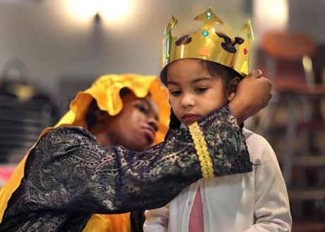Thamar Fleranvil, dressed as King Melchior, placed a decorated crown on Valerie Ruiz, 5.
