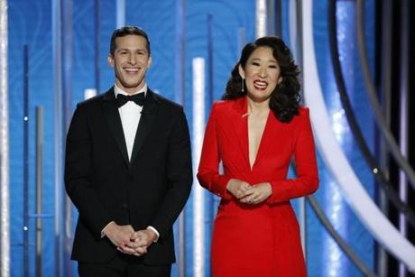 This image released by NBC shows hosts Andy Samberg, left, and Sandra Oh at the 76th Annual Golden Globe Awards at the Beverly Hilton Hotel on Sunday, Jan. 6, 2019, in Beverly Hills, Calif. (Paul Drinkwater/NBC via AP)
