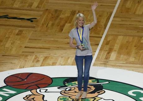 Boston Marathon bombing survivor Adrianne Haslet waved after being given the ?Heroes Among Us? award at TD Garden in April 2016. 
