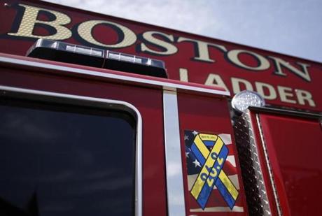 A ribbon honoring the victims of the Boston Marathon bombings is seen on the side of Mattapan Ladder 29 as the new ladder trucks enter Boston Fire Department service in South Boston, Massachusetts August 19, 2013. (Jessica Rinaldi For The Boston Globe)
