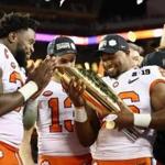 SANTA CLARA, CA - JANUARY 07: Kendall Joseph #34, Hunter Renfrow #13 and Adam Choice #26 of the Clemson Tigers celebrate with the trophy after their 44-16 win over the Alabama Crimson Tide in the CFP National Championship presented by AT&T at Levi's Stadium on January 7, 2019 in Santa Clara, California. (Photo by Ezra Shaw/Getty Images)