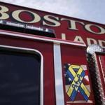 A ribbon honoring the victims of the Boston Marathon bombings is seen on the side of Mattapan Ladder 29 as the new ladder trucks enter Boston Fire Department service in South Boston, Massachusetts August 19, 2013. (Jessica Rinaldi For The Boston Globe)