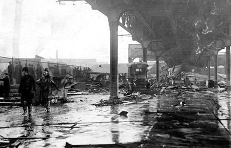 MOLASSES SLIDER Boston, MA - 1/15/1919: On Jan. 15, 1919, a giant tank in the North End collapsed, sending a wave of an estimated 2.3 million gallons of molasses through the streets of Boston, killing 21 people and injuring 150. The flood knocked down a house and smashed vehicles up and down Commercial Street, seen here. (Boston Globe Archive/) --- BGPA Reference: 150114_MJ_001
