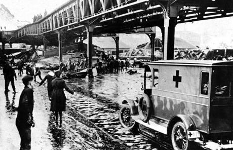 MOLASSES SLIDER Boston, MA - 1/15/1919: Police, firemen, Red Cross workers, civilian volunteers, and cadets from the USS Nantucket training ship berthed nearby rushed to the scene on Jan. 15, 1919, after a giant tank in the North End collapsed, sending a wave of an estimated 2.3 million gallons of molasses through the streets of Boston. They rescued many terrified people but others they were unable to reach. Twenty-one people died and 150 were injured. (Boston Globe Archive/) --- BGPA Reference: 150115_MJ_006
