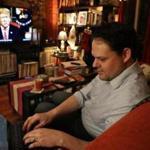 East Boston MA 1/8/19 Matt Cameron an immigration lawyer using Twitter and Facebook while watching President Donald Trump's speech about the boarder in his living room. (photo by Matthew J. Lee/Globe staff) topic: reporter: 