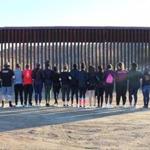 Regis college students stood facing the Mexican border in Southern California.