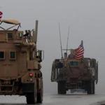 (FILES) In this file photo taken on December 30, 2018, shows a line of US military vehicles in Syria's northern city of Manbij. - The US military has removed some equipment from Syria, a defense official confirmed on January 10, 2019, following a report that the drawdown ordered by President Donald Trump is now underway. 