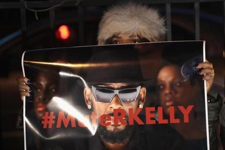 CHICAGO, ILLINOIS - JANUARY 09: Demonstrators gather near the studio of singer R. Kelly to call for a boycott of his music after allegations of sexual abuse against young girls were raised on the highly-rated Lifetime mini-series 