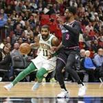 Boston Celtics guard Kyrie Irving (11) drives to the basket against Miami Heat guard Dwyane Wade (3) during the second half of an NBA basketball game, Thursday, Jan. 10, 2019, in Miami. (AP Photo/Joel Auerbach)