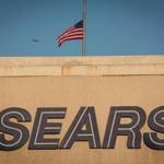 An American flag flies at half-staff above a Sears store in San Bruno, Calif., on Dec. 28, 2018. MUST CREDIT: Bloomberg photo by David Paul Morris.