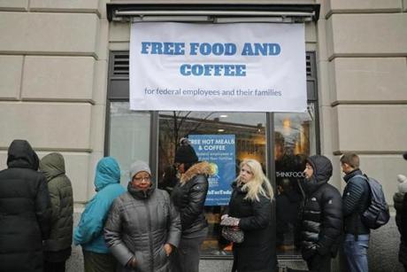 People wait in line at Chef Jose Andres' World Central Kitchen for free meals to workers effected by the government shutdown, Wednesday, Jan. 16, 2019 in Washington. Andres opened his World Central Kitchen feeding site on Pennsylvania Ave., to provide food to furloughed workers and their families. (AP Photo/Pablo Martinez Monsivais)
