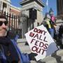 Employees affected by the partial federal government shutdown rallied earlier this week in front of the State House.