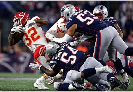 Foxborough, MA - 10/14/2018 - (2nd quarter) Kansas City Chiefs running back Spencer Ware (32) is wrapped up by a host of New England Patriots defenders. The New England Patriots host the Kansas City Chiefs in a Sunday night NFL game at Gillette stadium in Foxborough. - (Barry Chin/Globe Staff), Section: Sports, Reporter: Jim McBride, Topic: 15Patriots-Chiefs, LOID: 8.4.3482575762.
