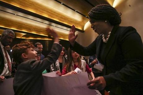Congresswoman Ayanna Pressley gave high-fives to children on Friday after speaking at a Temple Israel gathering dedicated to the vision of the Rev. Martin Luther King Jr.
