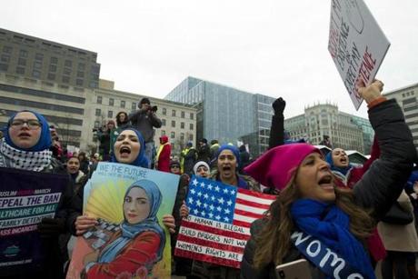 A group hold up signs at freedom plaza during the women's march in Washington on Saturday, Jan. 19, 2019. (AP Photo/Jose Luis Magana)
