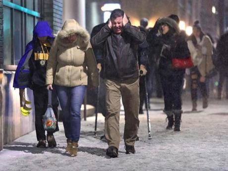 Snow starting falling heavily Saturday night as fans walk down Causeway Street at the end of the Bruins game against the NY Rangers at TD Garden. 
