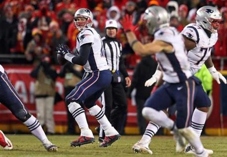 01-20-19: Kansas City, MO: Patriots quarterback Tom Brady (12) sees WR Julian Edelman (11, foreground right) raising his hand as he breaks open across the middle in the overtime period. Brady hit him for one of the key first down conversions that led to the New England victory. The New England Patriots visited the Kansas City Chiefs for the AFC Championship Game at Arrowhead Stadium. (Jim Davis /Globe Staff)
