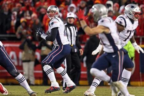 01-20-19: Kansas City, MO: Patriots quarterback Tom Brady (12) sees WR Julian Edelman (11, foreground right) raising his hand as he breaks open across the middle in the overtime period. Brady hit him for one of the key first down conversions that led to the New England victory. The New England Patriots visited the Kansas City Chiefs for the AFC Championship Game at Arrowhead Stadium. (Jim Davis /Globe Staff)
