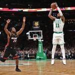 Boston MA 1/21/19 Boston Celtics Kyrie Irving shooting a three point basket over Miami Heat Justice Winslow during second quarter NBA action at TD Garden. (photo by Matthew J. Lee/Globe staff) topic: 21fans reporter: 