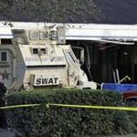 A Sebring, Fla., police officer stood near a Highlands County Sheriff?s SWAT vehicle station in front of the SunTrust Bank branch in Sebring, Fla., where the shooting occurred. 