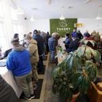 Customers crowd in after waiting on line in the cold on the opening day of recreational marijuana sales at Theory Wellness in Great Barrington, Mass., Friday, January 11, 2019. Theory is the first dispensary in the Berkshires to open its doors for recreational marijuana sales and the opening makes Theory the 6th dispensary of its kind in the state. (Stephanie Zollshan/The Berkshire Eagle via AP)