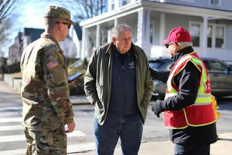 National Guardsman Jacob Tucker and disaster-response team member Walt Maize checked the well-being of resident Stewart Abramson.
