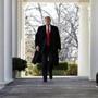 President Donald Trump walks through the Colonnade from the Oval Office of the White House as he arrives to announce a deal to temporarily reopen the government, Friday, Jan. 25, 2019, from the Rose Garden of the White House in Washington. (AP Photo/Jacquelyn Martin)