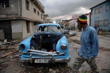 A damaged car flattened by debris from a building in Havana, Cuba. 
