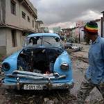 A damaged car flattened by debris from a building in Havana, Cuba. 