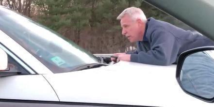 Richard Kamrowski of Framingham clung onto another driver?s hood after the car was stopped on the Mass. Pike Friday during a road rage incident.  

